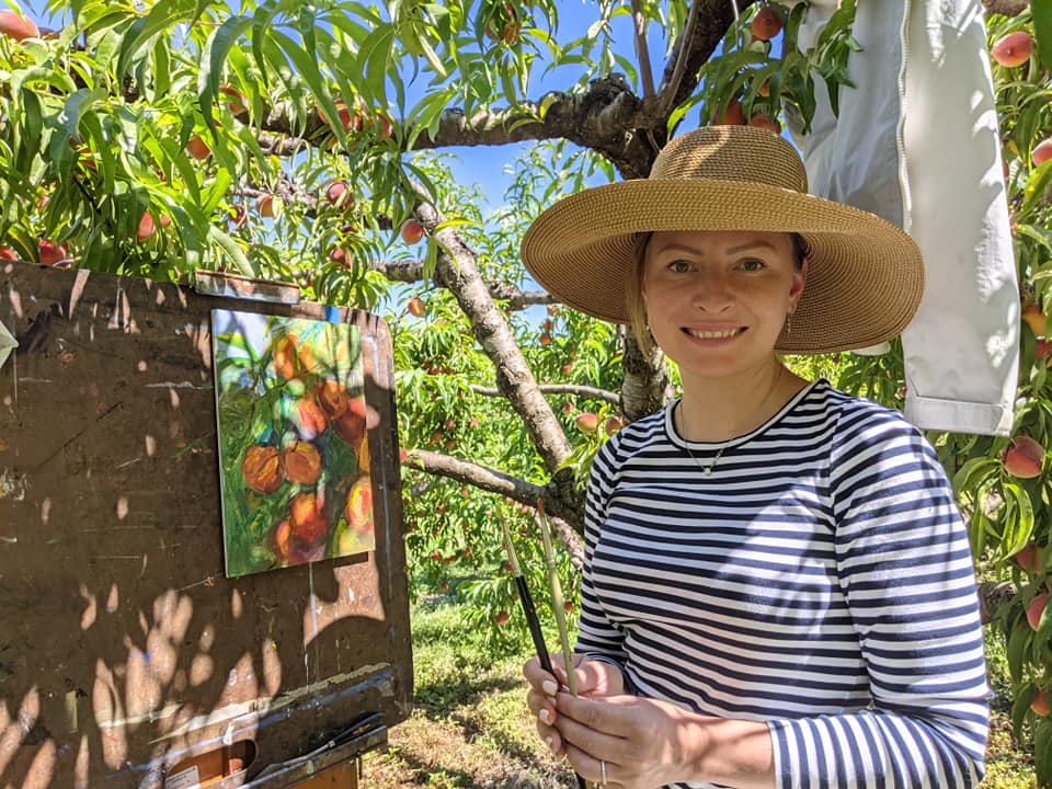 Alena Dixon painting peaches at Grelen orchard.
